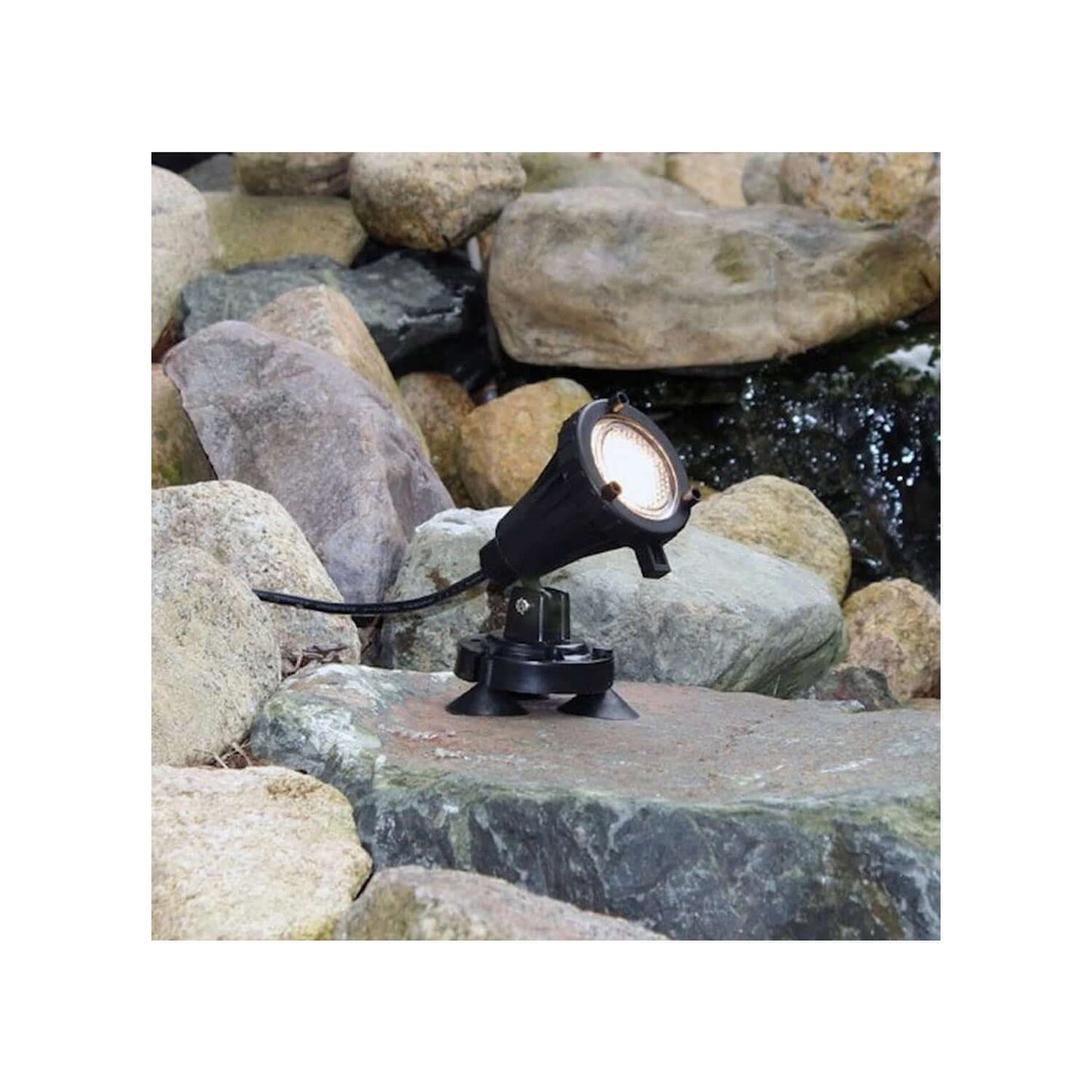 Alt Tag: 6 Watt Stainless Steel Underwater LED Light warm white pond spotlight on rocks, durable housing, 80,000-hour LED