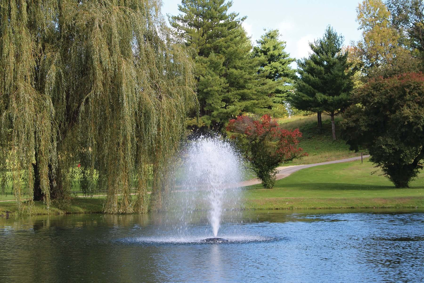 Alt Tag: Kasco 3400JF 3/4 HP J Series Decorative Pond Fountain spraying decorative water display in mid-size pond