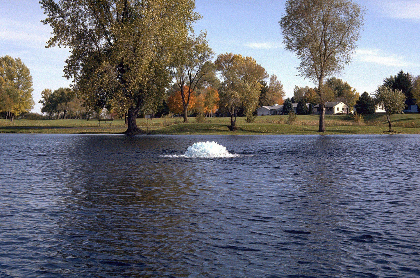 Kasco Marine 8400HAF 2 HP surface pond aerator 240V operating in a lake, creating surface spray to improve water circulation and aeration