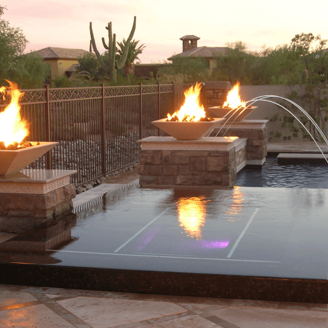 Outdoor fire bowl and water feature using 18 inch 24 volt AC electronic ignition system for reliable all-weather flame ignition