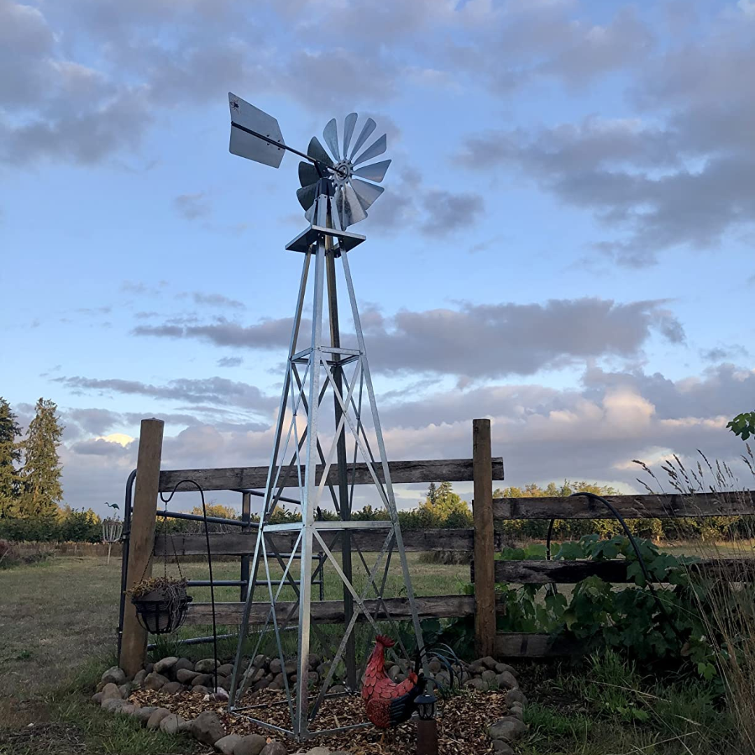 Side angle of the Galvanized Backyard Ornamental Windmill - 8', highlighting the sturdy 4-legged tower design and overall aesthetic appeal.