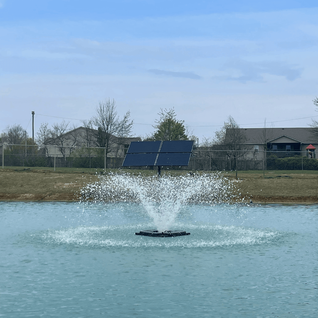 Outdoor Water Solutions Aerify solar pond aeration fountain spraying water in a pond with solar panels on shore