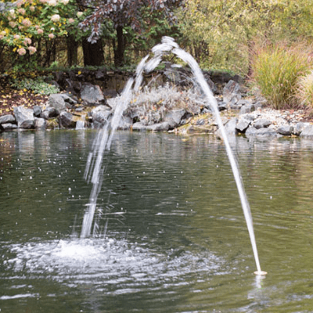 flush mount arching jet nozzle for splash pads and pools creating a clear arcing water stream in a pool