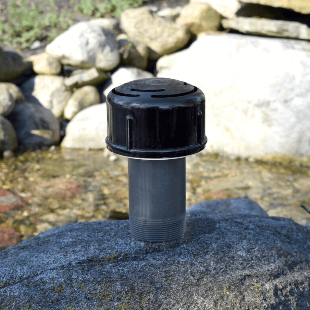 2 inch NPT narrow umbrella fountain nozzle PVC with black cap on rock by pond, EasyPro focused dome spray for large fountains