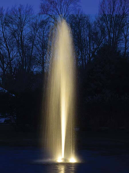 Easypro 1 HP Aqua Fountain floating pond fountain at night with illuminated rocket spray jet creating tall vertical water plume