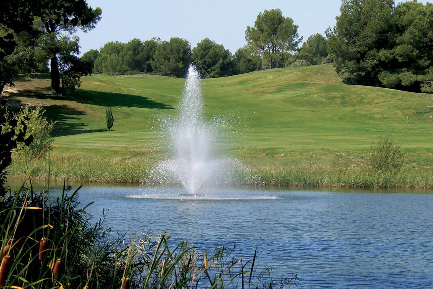 Otterbine Tri Star floating pond fountain spraying three-tier water display on lake, improving circulation and oxygenation