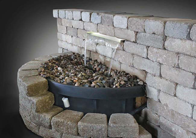 23.5" Vianti Falls Waterfall Kit Without Lights - Elegant Stainless Steel Spillway System installed in block wall, sheet waterfall into basin