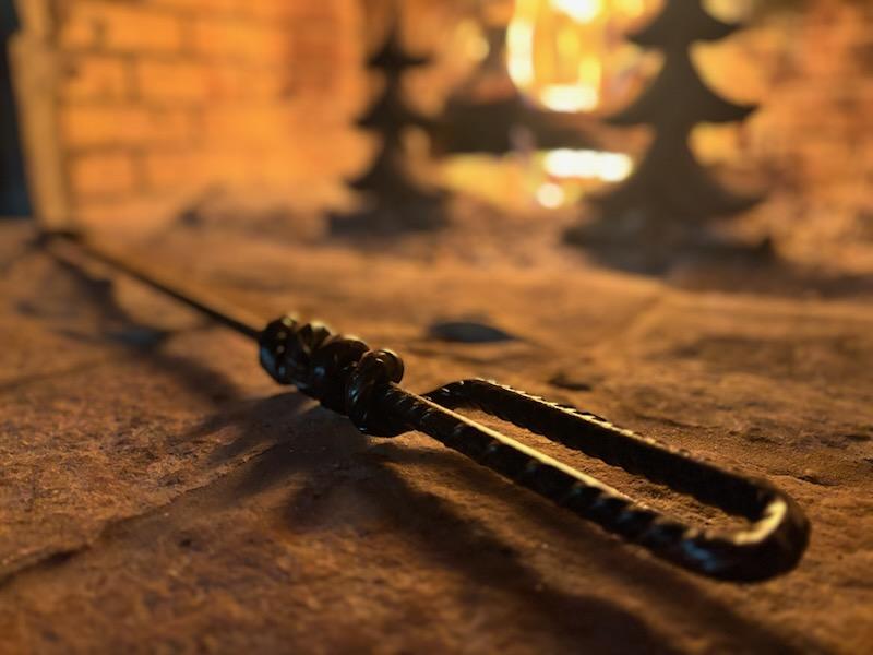 Close-up of the Good Works Hand Twisted Fire Poker highlighting its unique twisted design and sturdy construction.