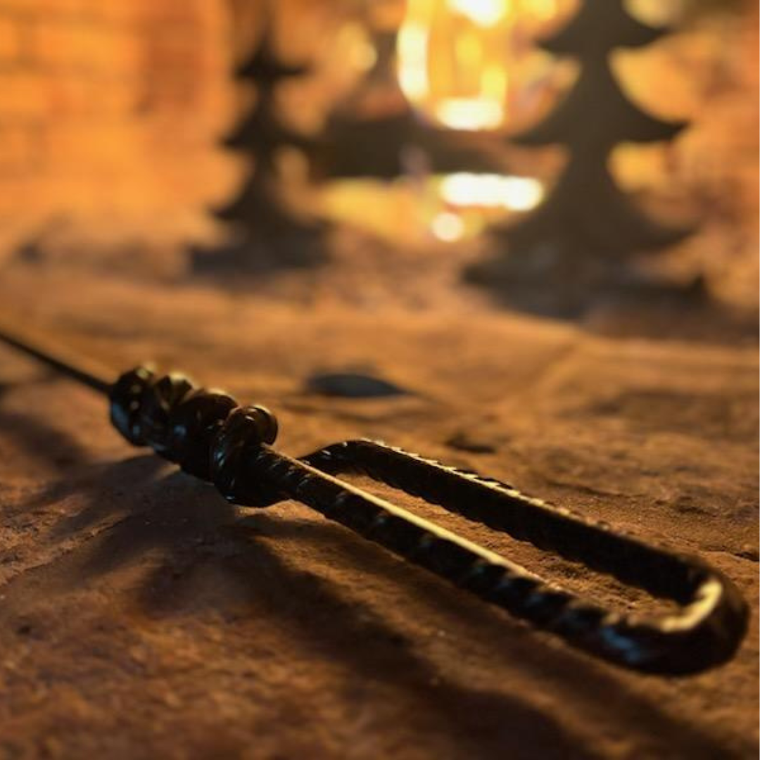 Good Works Hand Twisted Fire Poker showcasing its unique handcrafted design and high-quality materials.