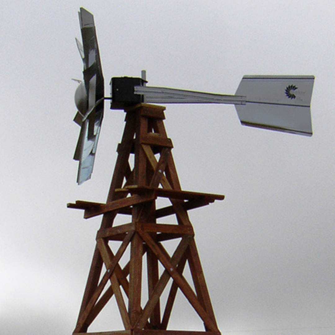 Detail of the Grand Wooden Ornamental Windmill - 16' highlighting the sturdy 4-legged design and light cedar-colored pressure-treated wood.