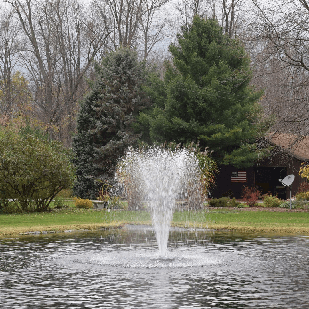 Alt Tag: AquaFloat™ Floating Fountain Head with Narrow Umbrella Nozzle creating narrow umbrella spray in backyard pond fountain
