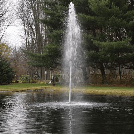 AquaFloat™ Floating Fountain Head with Rocket Nozzle creating tall rocket spray fountain in pond with 24-inch floating base