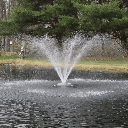 Alt Tag: AquaFloat™ Floating Fountain Head with Wide Umbrella Nozzle spraying wide umbrella pattern on pond with floating fountain head