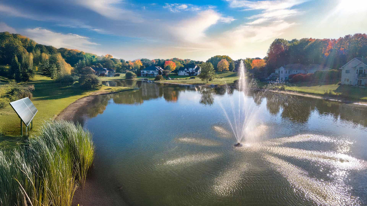 Scott Aerator Solar Atriarch 1/2 HP solar pond fountain spraying 9-jet pattern on lake with two-panel solar power