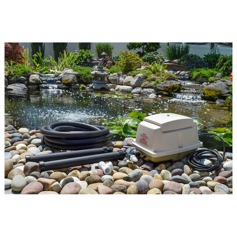 EasyPro LA15W linear pond aerator kit with compressor, weighted airline and diffuser beside a garden pond