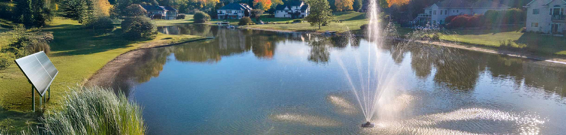 Scott Aerator Solar Atriarch 1/2 HP solar pond fountain with solar panel powering high spray display in landscaped lake