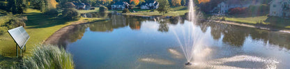 Scott Aerator Solar Atriarch 1/2 HP solar pond fountain with solar panel powering high spray display in landscaped lake