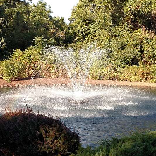 Otterbine Constellation floating aerating fountain with multi-tier starburst spray installed on a pond