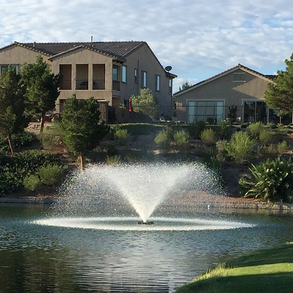 Otterbine Sunburst floating aerating fountain with fan-shaped spray installed on a pond