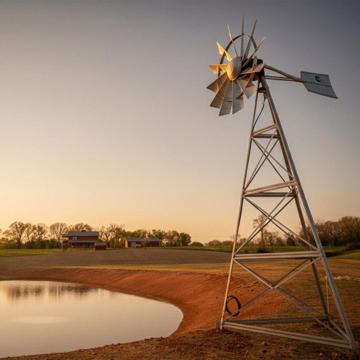 Outdoor Water Solutions windmill pond aerator on a farm pond bank