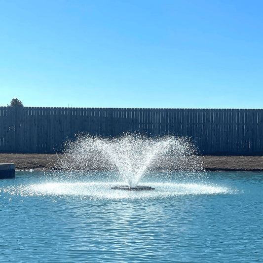 Aerify 1/2 HP electric pond fountain aerator with carnival spray pattern running on a pond