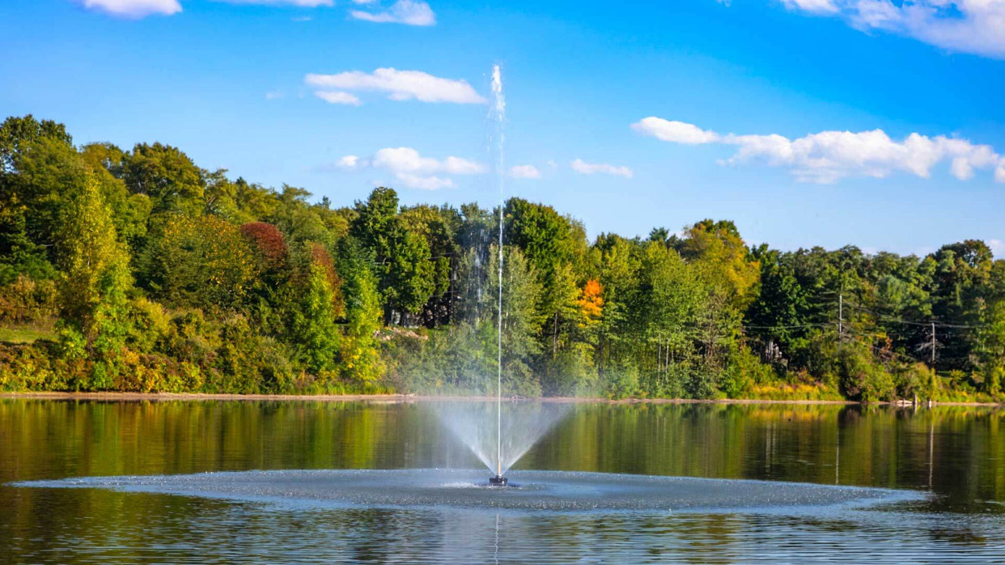 Scott Aerator Solar Skyward 1/2 HP solar pond fountain spraying tall vertical jet on lake, off-grid two-panel solar system