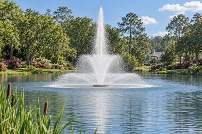 Otterbine Tri Star floating pond fountain spraying a three-tier pattern in a landscaped pond